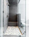 The Botany Bay Sliced Pebble shower floor adds an extra flair to this condo’s master bathroom