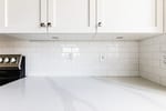 Daltile Rittenhouse Square Artic White Glossy Tile Backsplash in Mid-Rise-Dallas-Condo-Kitchen