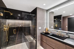 Master bath with no-hardware vanity and gold fixtures by StyleCraft Cabinets, TX.