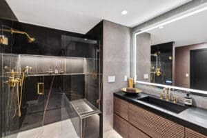 Master bathroom with no-hardware vanity and gold accents by StyleCraft Cabinets, Texas.