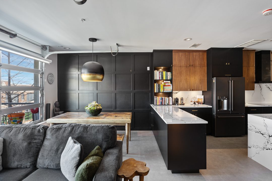 Living Room View of Kitchen and Skyline After Remodeling by the Renowned Group