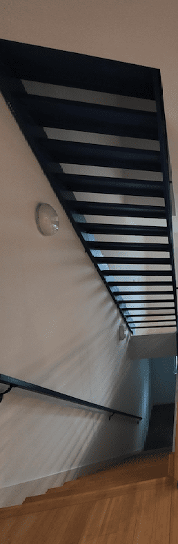 Stairs to the bottom level in Dallas Urban condo conversion before remodeling